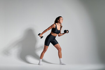 fitness girl wearing black outfit with weights