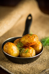 whole fried young potatoes in a pan