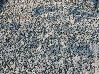 Gravel stone background. Shadows are reflected on the surface.
