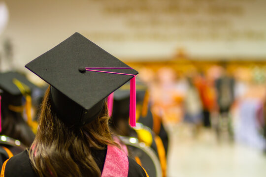 The image of a graduation hat from the back of a successful university graduate