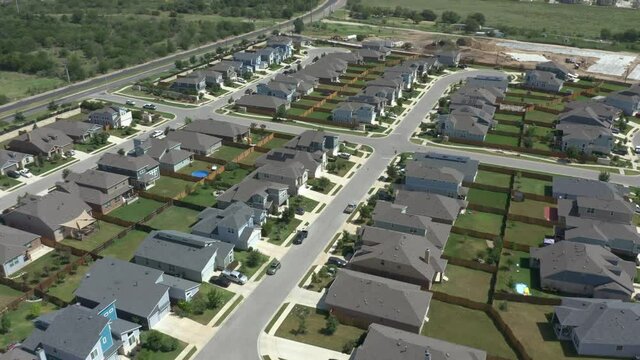 Aerial view of suburban houses, drone flight down suburban street