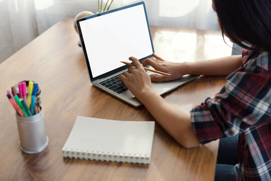 Female student using laptop computer at home for learning global connectivity technology and studying through online E-learning System concept. Preparing Students for Life and Work. Mockup screen.
