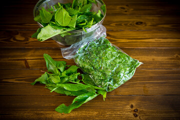 fresh green sorrel in a vacuum bag, in a colander