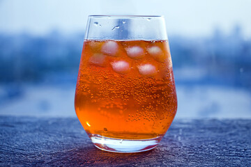 Italian Aperol Spritz alcohol cocktail with ice cubes. Summer refreshing orange drink with bitter, sparkling wine prosecco and soda. Copy space for text