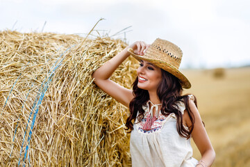 Beautiful cowboy woman Posing near at the haystacks, Fashion concept.