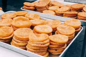 Fried pies with white sesame sold at street vendor in china. Chinese snacks.