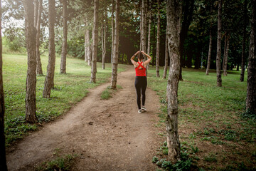 Obraz premium Young sporty woman jogging through the forest