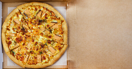 pizza with seafood, red fish, shrimps, on thin traditional Italian dough, in a box, place to print