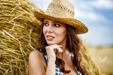 Beautiful cowboy woman Posing near at the haystacks, Fashion concept.