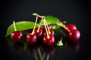 ripe red natural cherry on a black