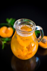 cold apricot compote in a glass decanter