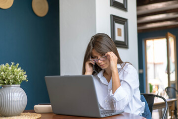 Young business woman reading report on her laptop computer.