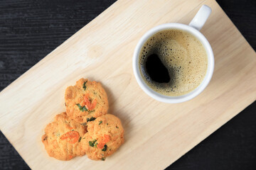 Top view of coffee cup and dried shrimps cookies, Thai style homemade cookies.