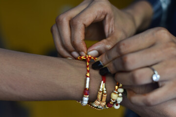Indian sister tie a traditional rakhi in a brother hand in raksha bandhan, Indian Traditional Festival
