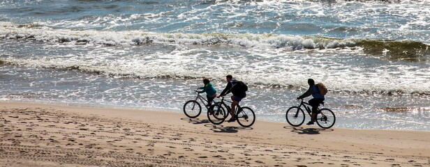 With bicycles on the beach