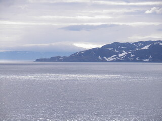 snow covered mountains in the sea, Norway