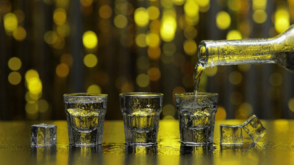 Barman pour frozen vodka from bottle into shot glass. Ice cubes against shiny gold party background