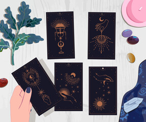 A session with a fortune teller with tarot cards, the interpreter's female hands lay out the suits of cards of fate for their guest, drink coffee and wait on arcane cards at the mystical guide
