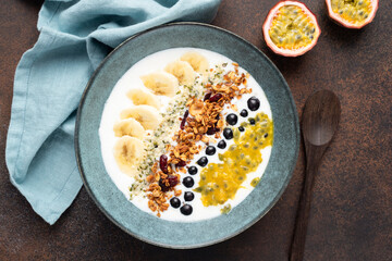 Yogurt granola bowl with fruits and hemp seeds. Healthy breakfast, vegetarian food