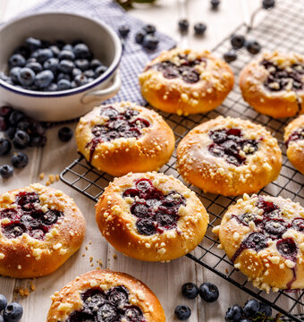 Yeast sweet rolls with the addition of blueberries and crumble close up view. Traditional kolaches