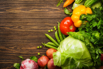 Assortment of fresh vegetables on wooden table background. Healthy organic food grocery concept. Copy space