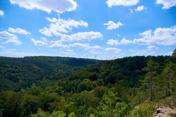 mountain landscape with blue sky and wind generators
