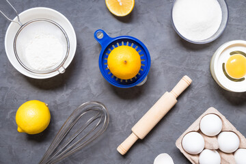 Top view raw ingredients for cooking lemon pie on dark background with copy space. Bakery background.