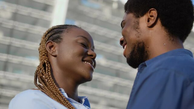 Happy black couple hugging admiring each other, love relationship, romantic date