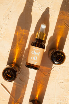 CBD oil bottles and droppers in sunlight