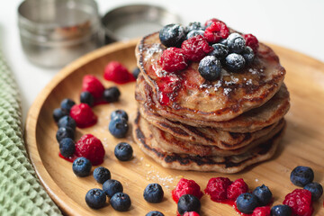 A heap of healthy vegan gluten-free whole grain pancakes made with buckwheat flour topped with...