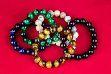 Stone Bead Bracelets on a Red Background