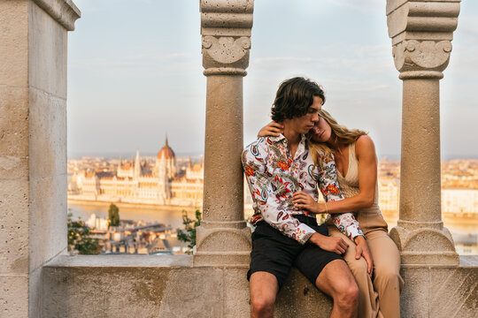 Couple in love hugging and a famous spot in Budapest behind