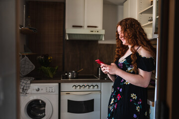 Selective view of a woman smiling a looking at her smartphone