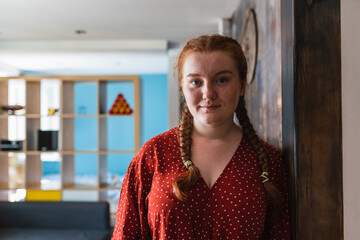 Portrait of a young woman with her red hair in braids