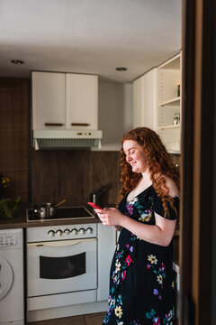 Selective view of a woman smiling a looking at her smartphone