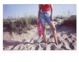 Cropped woman with pink inflatable.