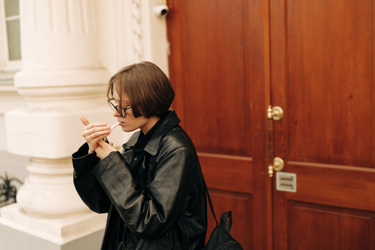 Real Androgyne Woman smoking on the street