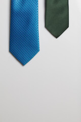 Two men's ties in different colors and sizes. For father and son. Love and Togetherness Objects. On a white background