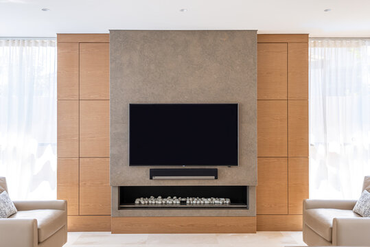 Modern minimalist family sitting area with flat screen and fire place