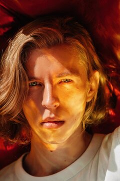 Handsome sensual man with surreal red flare on face