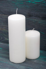 Fototapeta na wymiar Two large white candles. Love and Togetherness Objects. On painted boards.