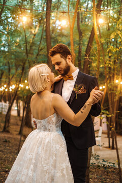 Beautiful Bride And Groom Dancing Outdoors On Their Wedding Day