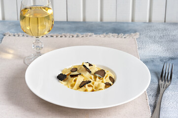 Dish of delicious italian pasta tagliatelle with truffle mushroom chips