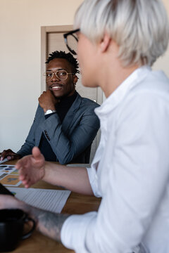 Stylish black man with colleague in office