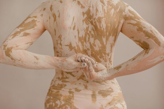 Dirty woman clasping hands behind back