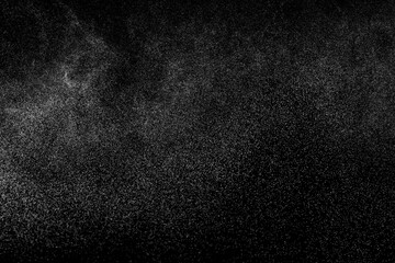 Abstract splashes of water on black background. Freeze motion of white particles. Rain, snow overlay texture.