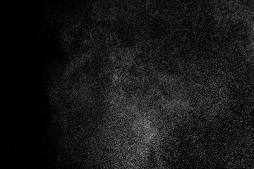Abstract splashes of water on black background. Freeze motion of white particles. Rain, snow overlay texture.