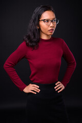 Portrait of young beautiful Asian businesswoman with eyeglasses