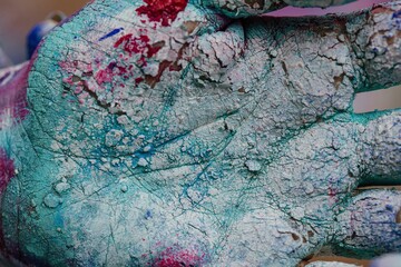 Hand covered with cracked paint