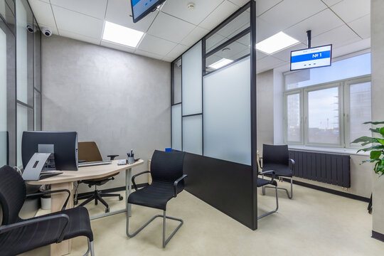 The modern cubicle office with glass panels, office furniture and  digital signages. Workplace in the modern sales office